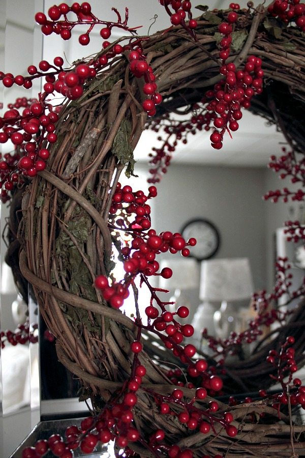 This DIY red berry wreath makes a beautiful festive holiday statement in your home and it only takes a few minutes and a few dollars to put together!