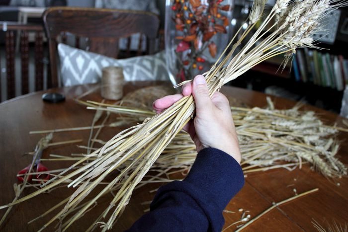 Quickly and easily make a wheat sheaf for your fall decor or harvest table centerpiece with this simple step-by-step guide.