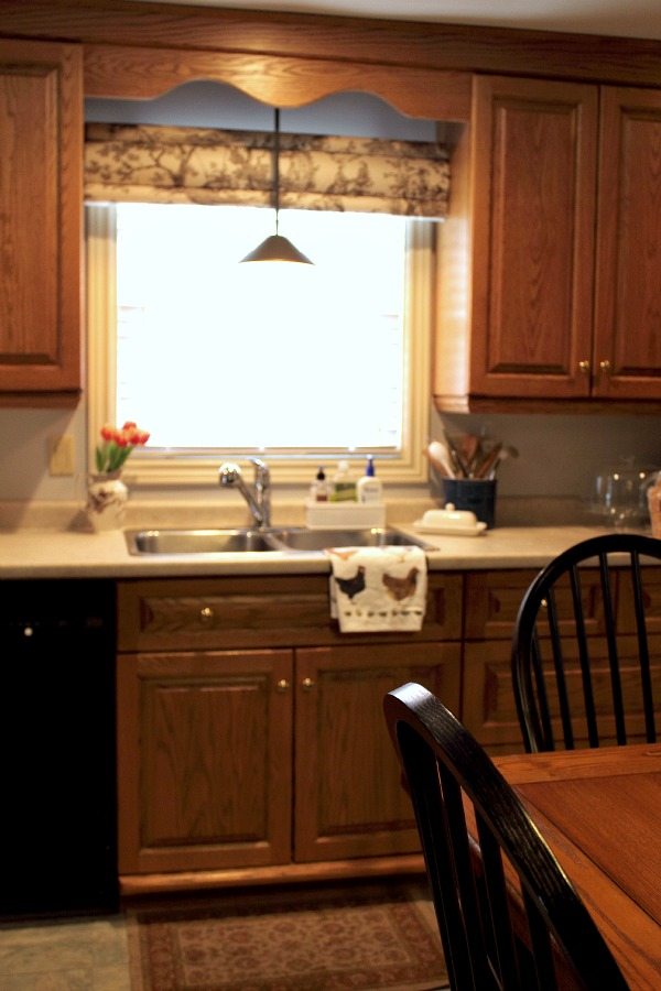 It's easy to update the look of your old kitchen cabinets with some simple mouldings and a few basic tools!