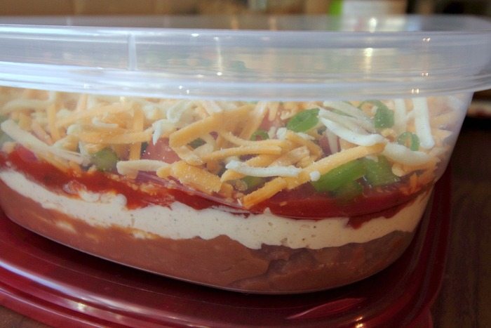 A great taco dip recipe that everyone loves so much, it's like it magically disappears!