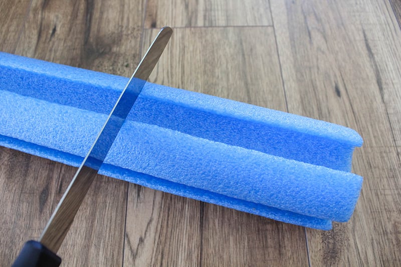 If you can never find a good place to put your brush down in between coats or when you're taking a break from painting, try making yourself a pool noodle paint brush stand!