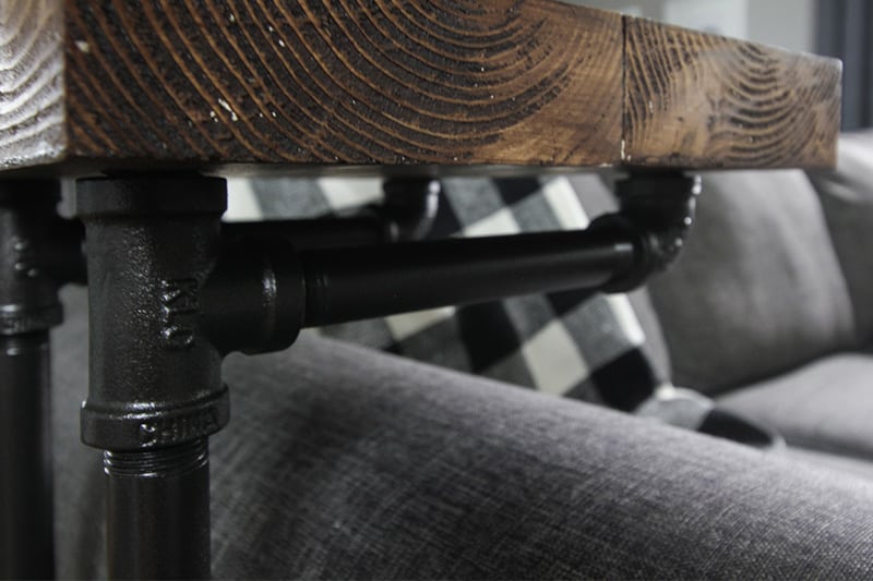 This sofa arm table is a great solution for small spaces and using plumbing pipe to make it gives it a fun industrial look! Here's how you can make a table just like this!