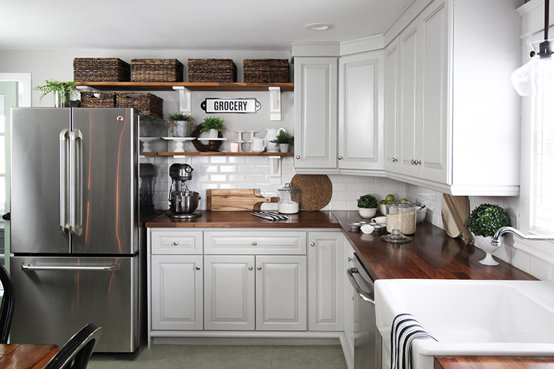 There are a few things you should know before you install open shelving in your kitchen like we have in ours. Read on to learn more about our experience, our tips for making it more functional, and some ideas for making it look great in your home.