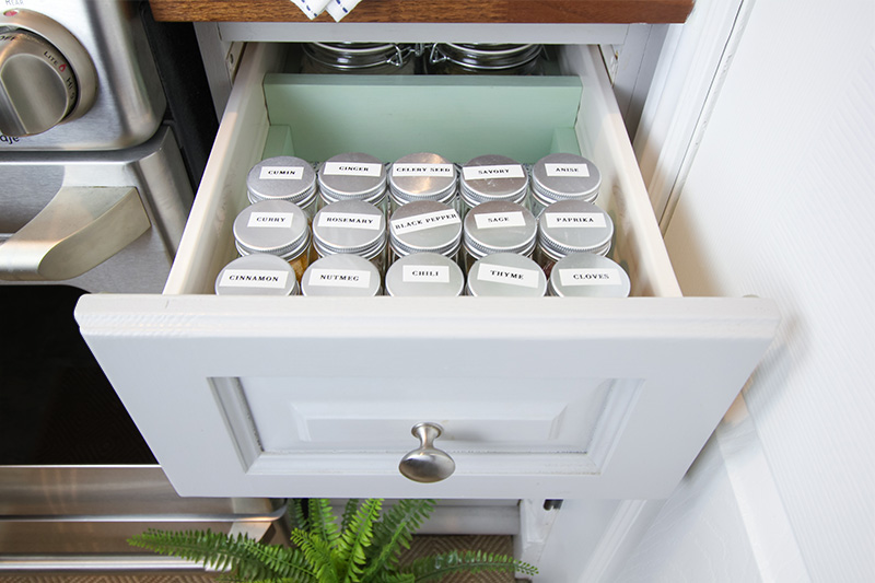 We created this super simple DIY spice drawer organizer to try to tame our jumble of different sizes of bags and bottles of herbs and spices. Not only does it look so much better, it's now much easier to find what I need exactly when inspiration strikes!