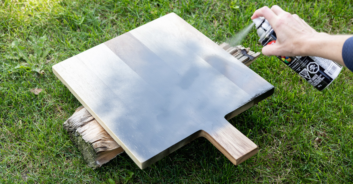 Spray painting a charcuterie board.