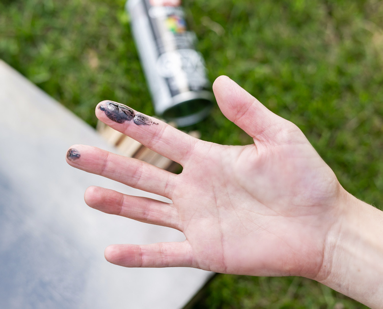 Black spray paint on fingers