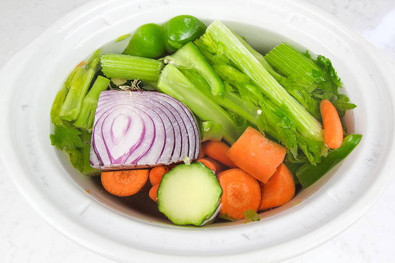 Use this Crock pot veggie stock recipe as an easy way to make use of your leftover veggies scraps, to improve your soup game, and to make your kitchen smell amazing!