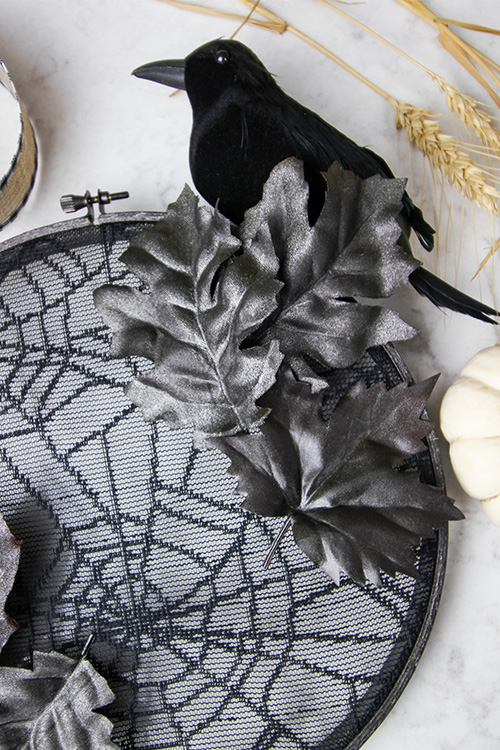 This embroidery hoop halloween wreath will help set a spooky tone for those coming up to your house and can be made with supplies from the dollar store!