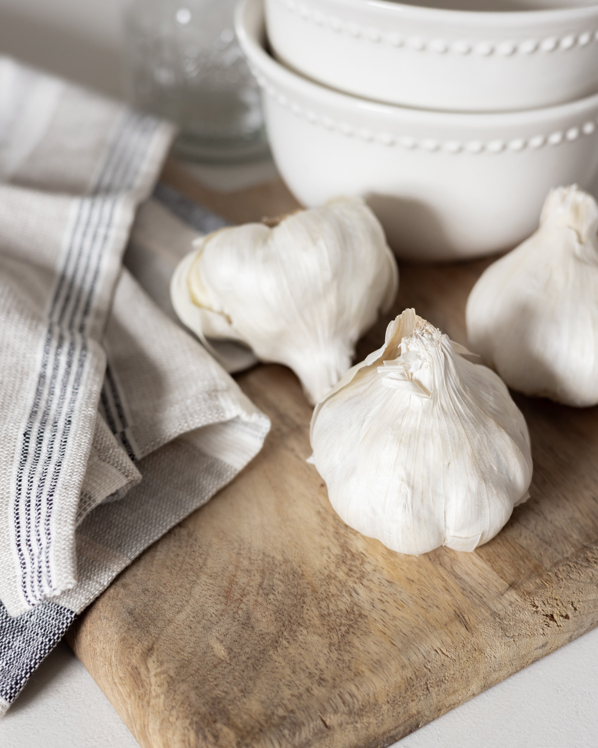Heads of garlic on a cutting board.