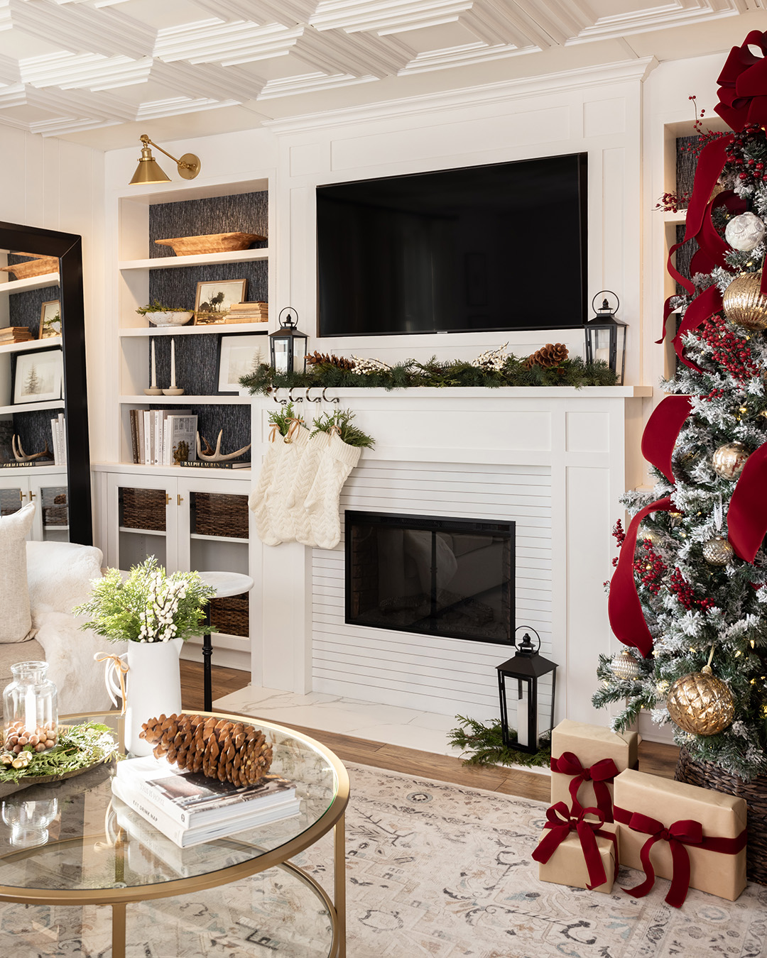 White Christmas living room with red Christmas tree.