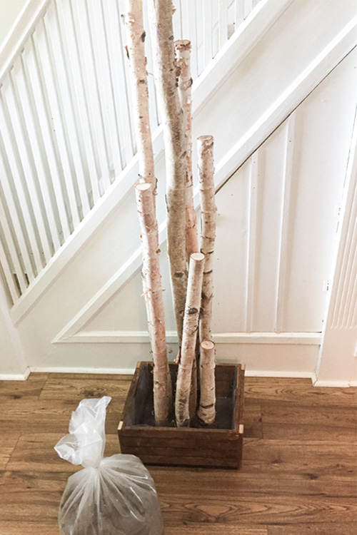 Create your own birch in a box Christmas planter for next to your front door with this easy tutorial! It's the perfect modern farmhouse style decor piece for your Christmas porch!