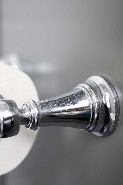 Hairspray can build up on surfaces in the bathroom over time and make them look corroded and dull. Here's how to clean hairspray off of bathroom fixtures!
