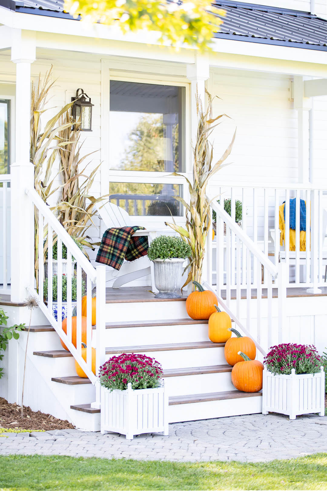 Fall weather is here! In today's post we'll share how we've decorated our classic farmhouse fall front porch this year with brightly coloured mums and cheerful orange pumpkins.