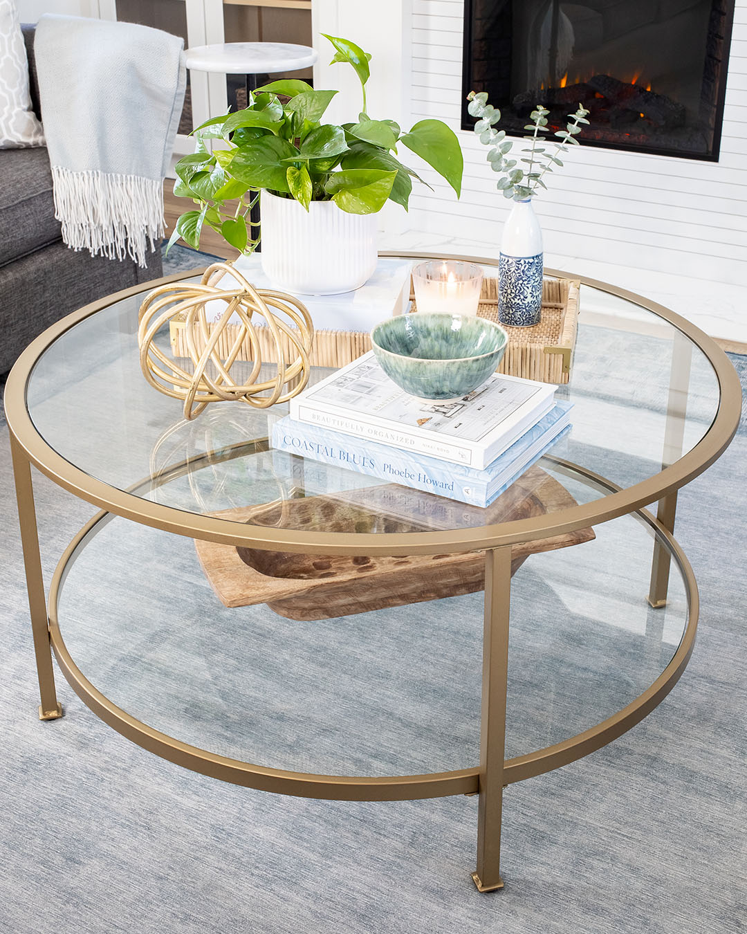 Today I thought I'd share a little peek at what our living room looks like right now and maybe give you a few ideas for styling a small round coffee table.
