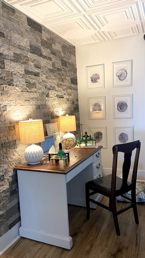 In today's post I'll share the details of how I whitewashed the faux stone wall behind my new desk nook to brighten up the whole space. Here's how to whitewash a stone wall.