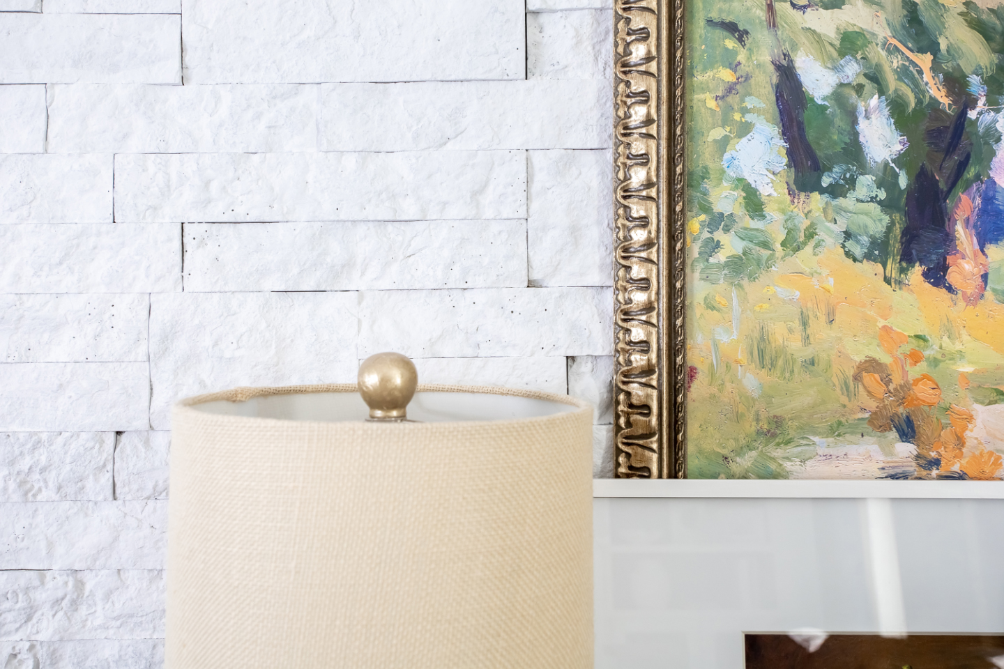 In today's post I'll share the details of how I whitewashed the faux stone wall behind my new desk nook to brighten up the whole space. Here's how to whitewash a stone wall.