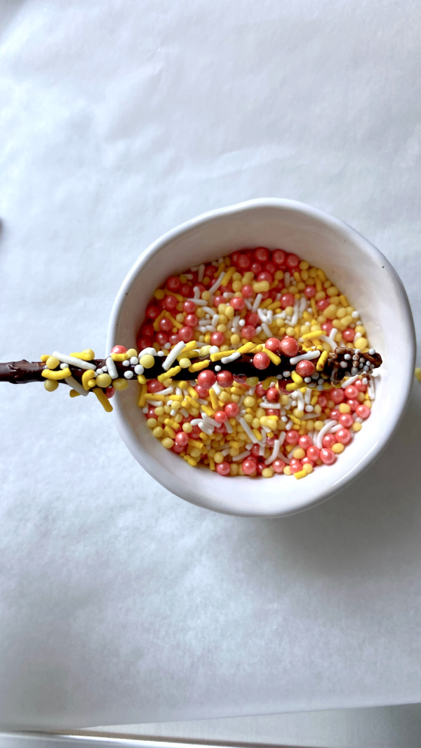 Just sharing this quick idea I had this weekend for a fun way to add some color to your Halloween cookie tray or snack table! Here's how to make Halloween sprinkle sticks!