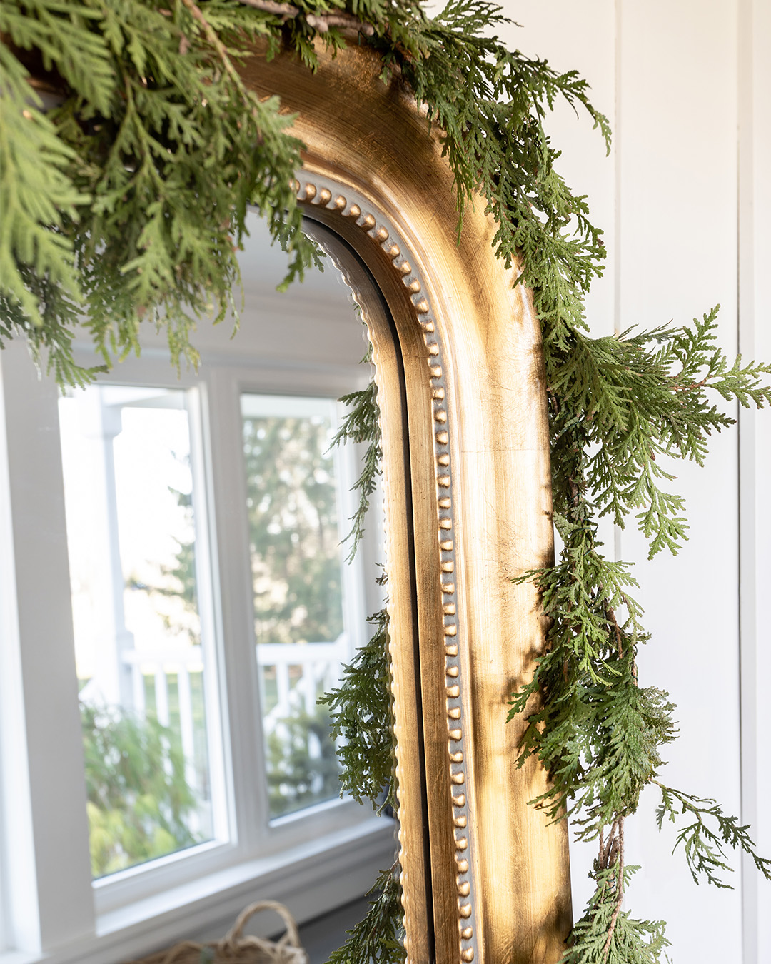 I went super simple for the mudroom this year and just headed out on a walk around the property to gather some greenery to bring a little Christmas cheer to our entryway. Here are my natural cedar Christmas decorations in our mudroom.