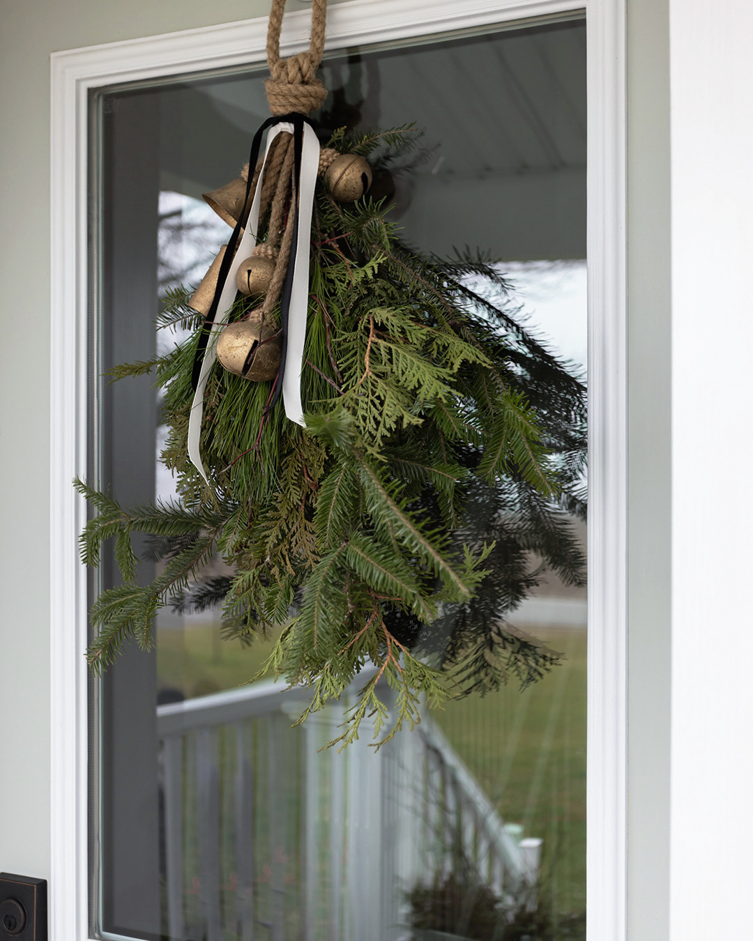 There's nothing like fresh greenery and it's even better if it comes from your own backyard. Grab your clippers and make this foraged Christmas door swag for your front door!