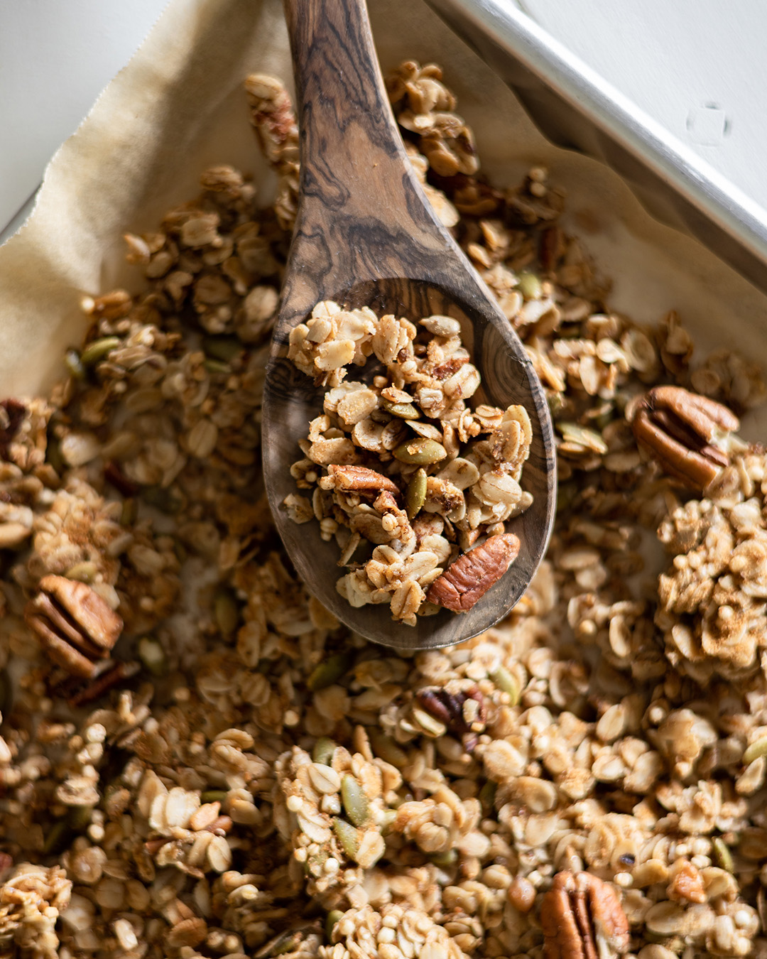 homemade maple pecan granola is great to keep on hand for easy breakfasts, delicious snacking, or fancy yogurt parfaits if you're entertaining for Sunday brunch. It can be made ahead and stored in the freezer so it's always ready.