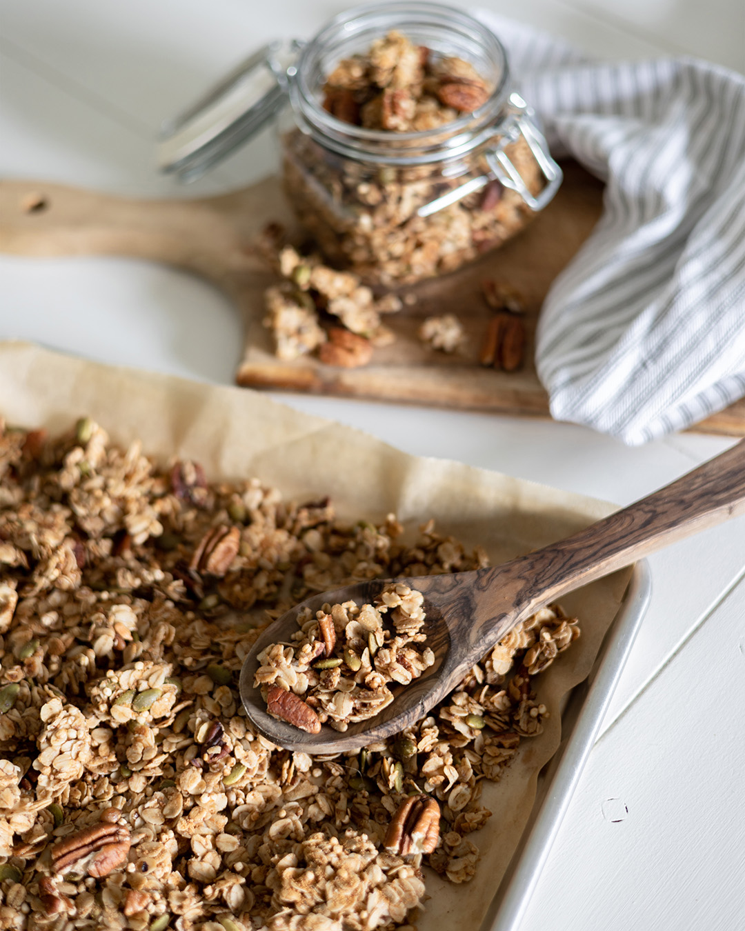 homemade maple pecan granola is great to keep on hand for easy breakfasts, delicious snacking, or fancy yogurt parfaits if you're entertaining for Sunday brunch. It can be made ahead and stored in the freezer so it's always ready.