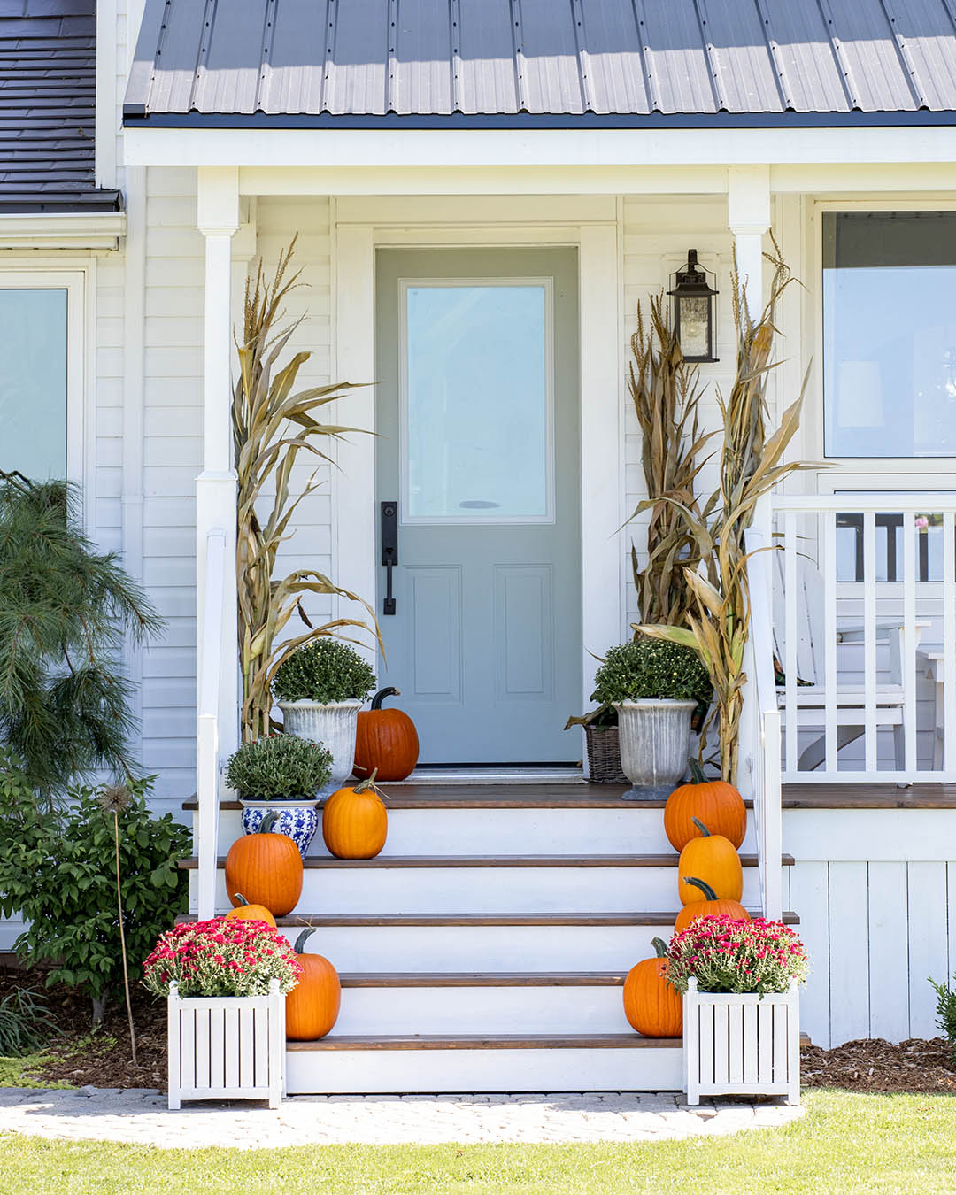 Bright and colourful fall decor on a farmhouse front porch.
