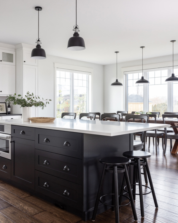 Timeless kitchen with black island and black drawer pulls.