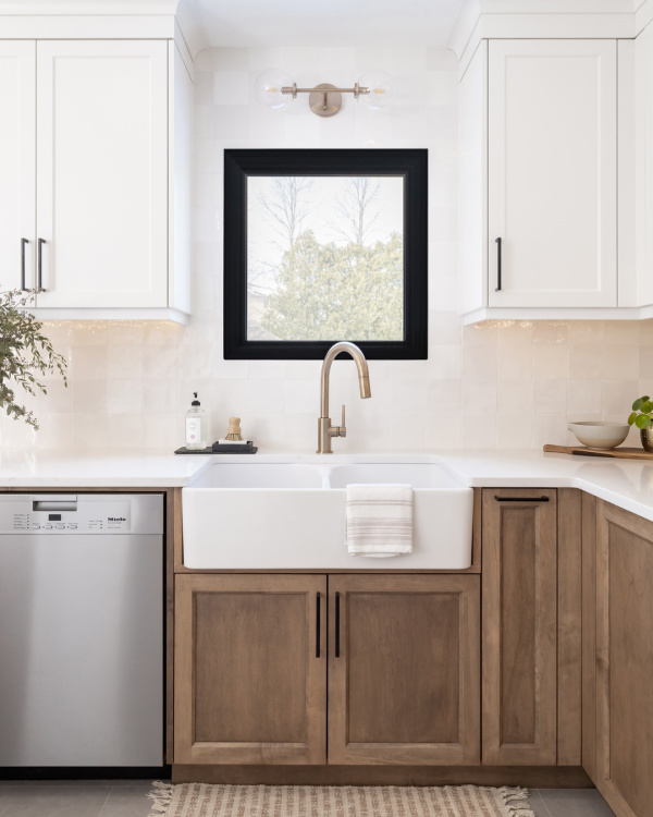 Medium wood tone cabinetry and a white farmhouse sink