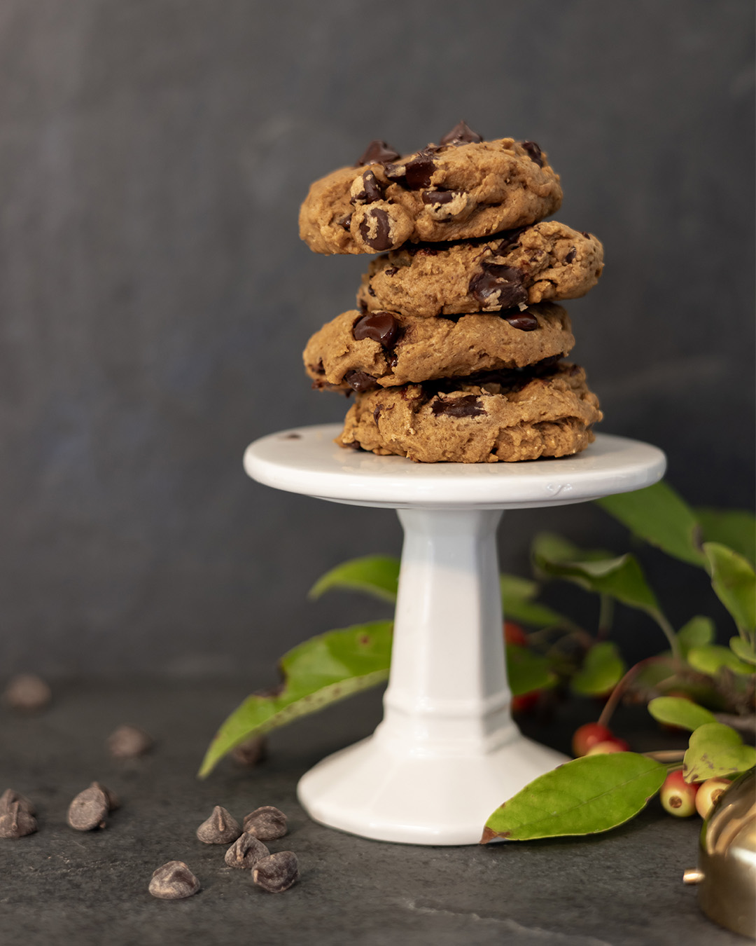 A beautiful stack of chocolate chip cookies made with pumpkin and pumpkin spice.