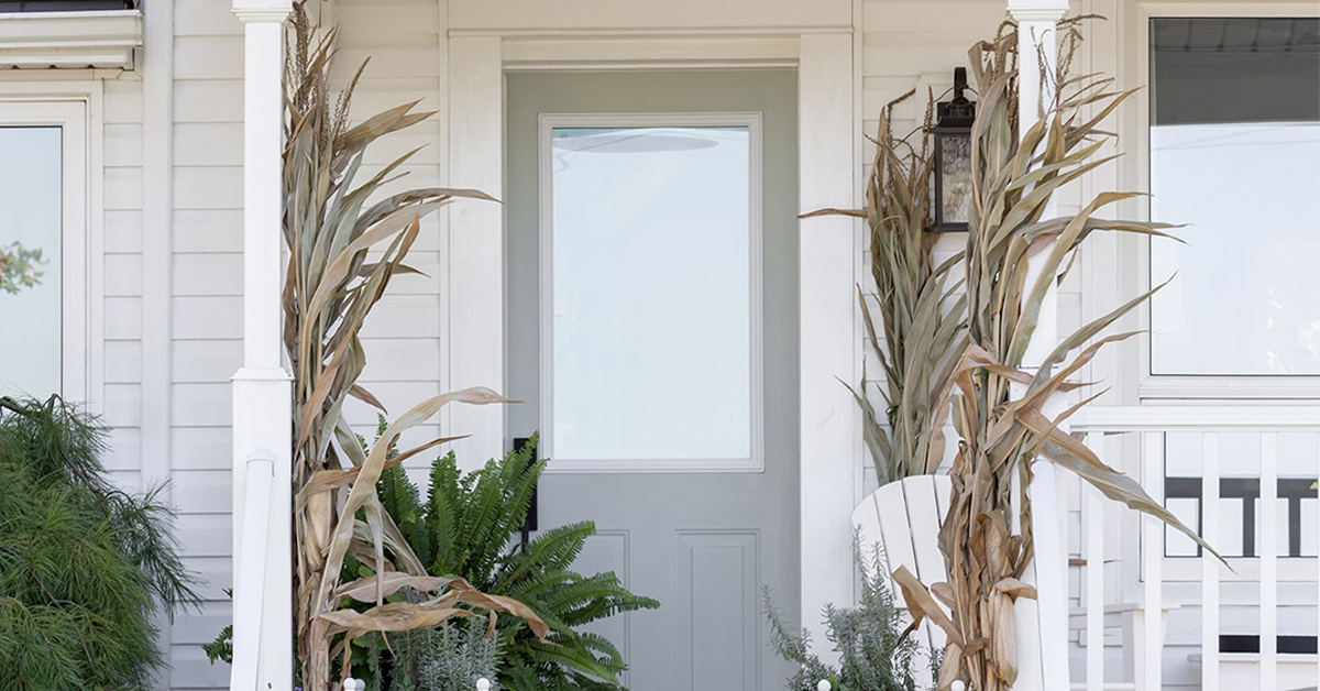 Set the tone for Halloween decor with dried corn bundles at the front door.