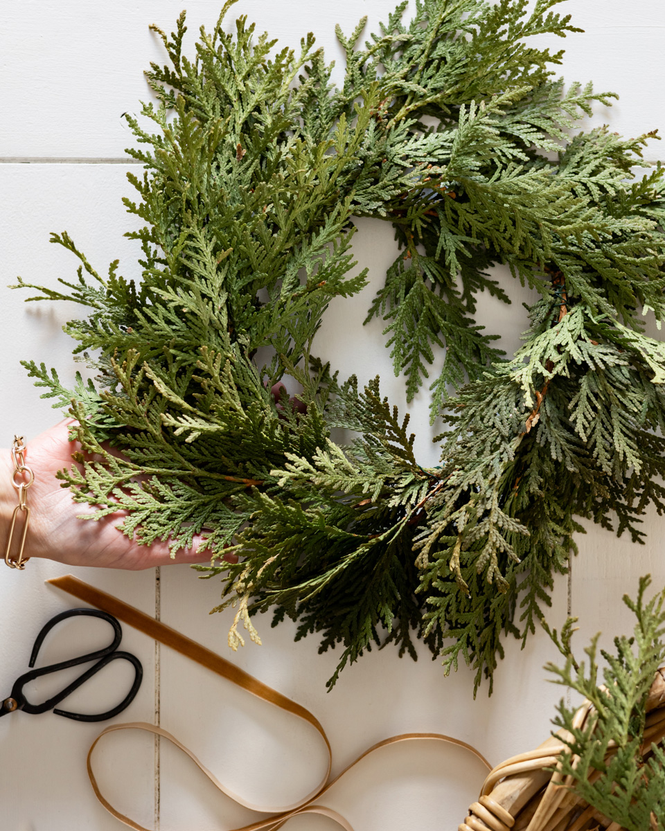 Putting the finishing touches on fresh cedar mini wreaths.