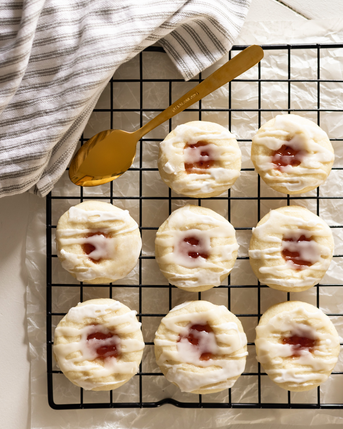 Thumbprint cookies drizzled with almond glaze.