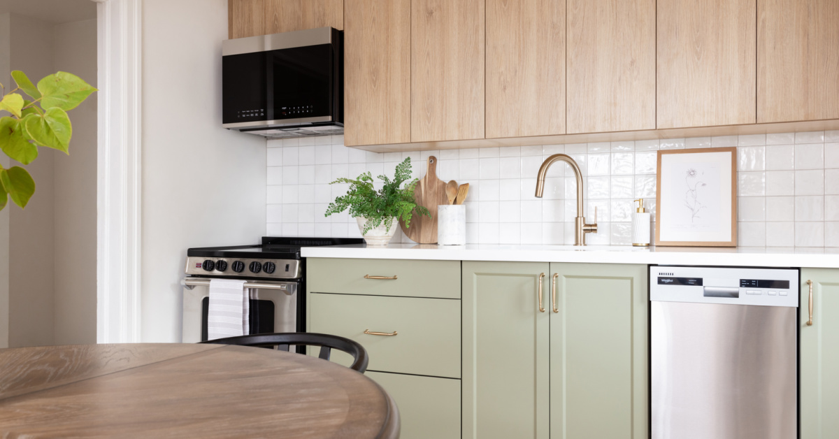 Green and wood two-tone kitchen cabinets.