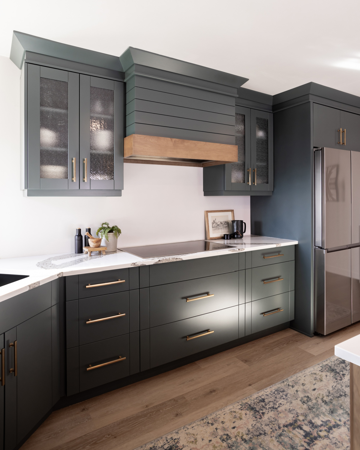 An elegant grey-green color was chosen for this modern farmhouse style kitchen.