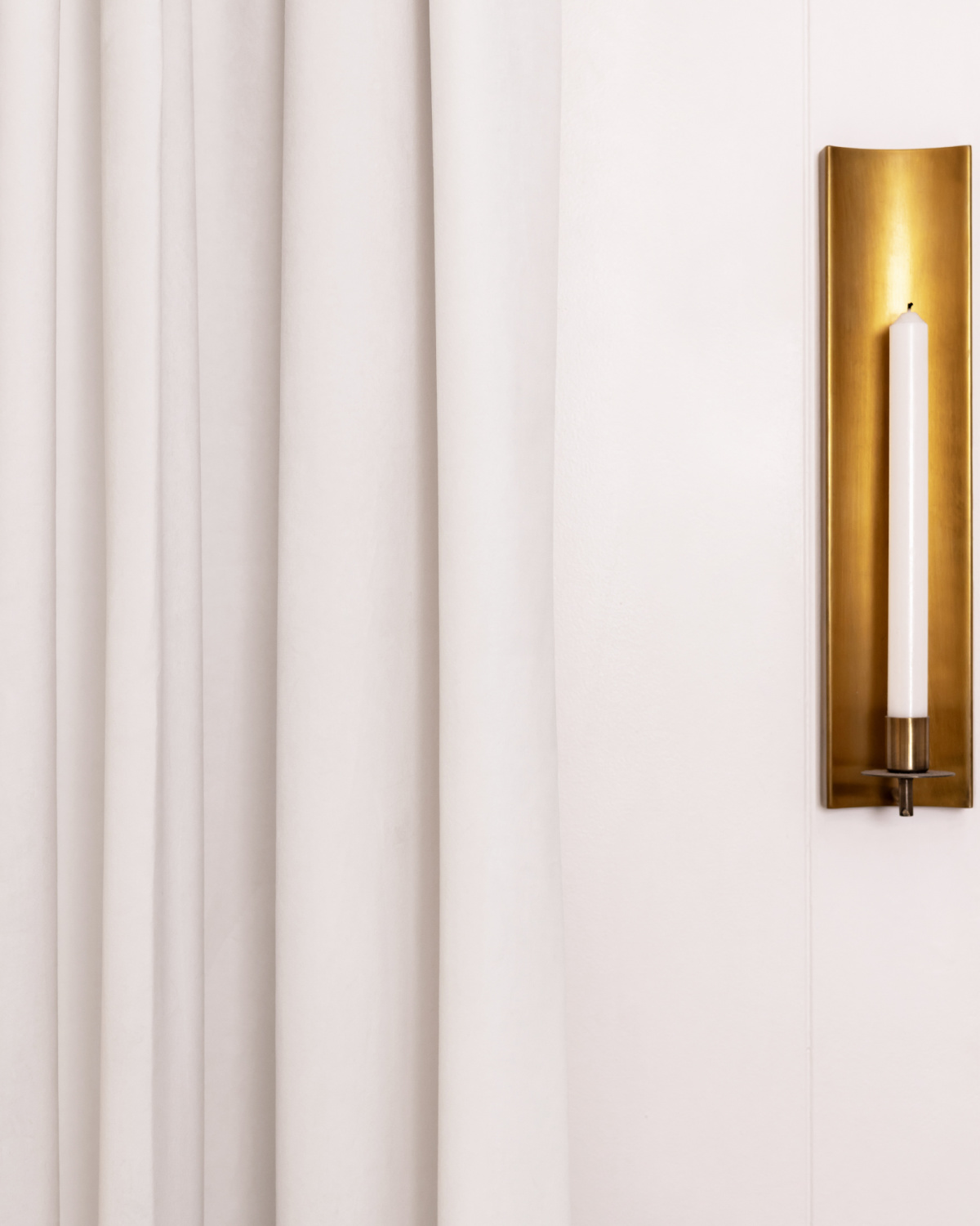 Benjamin Moore Simply White on walls with brass candle sconce.
