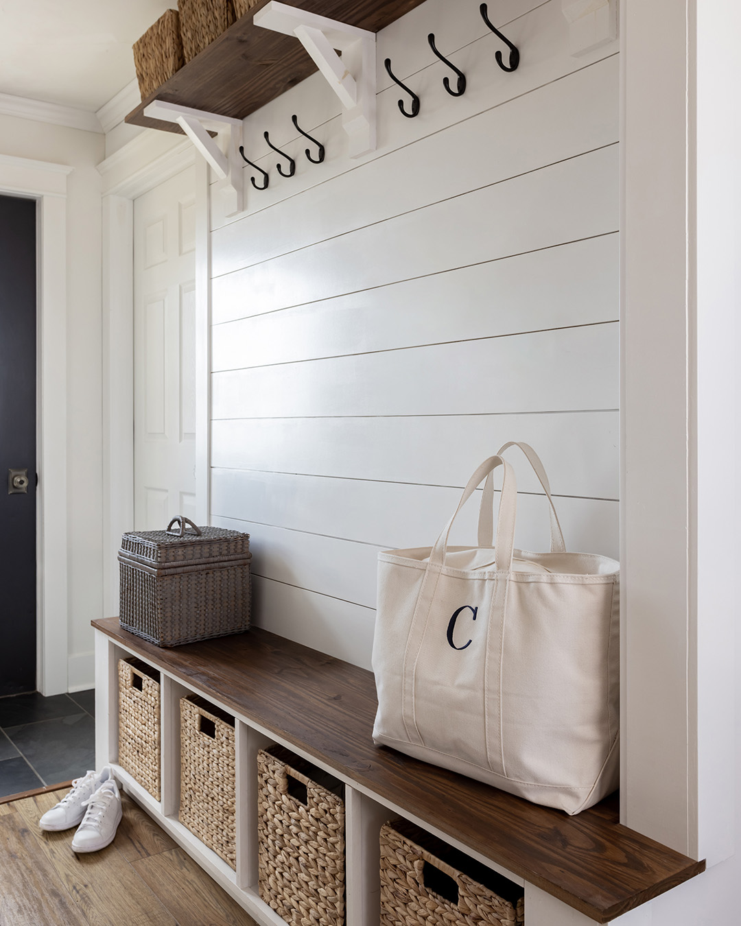 A compact mudroom area with hooks, cubbies, and baskets.
