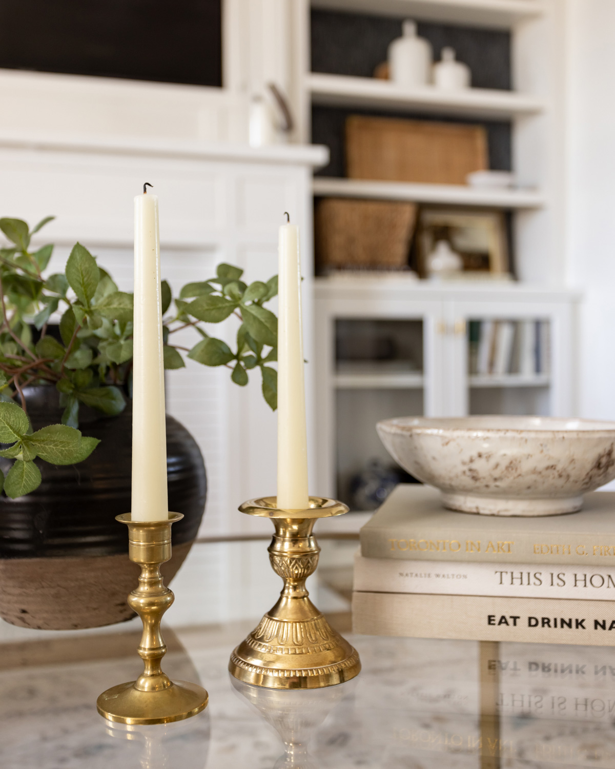 Thrift store books and candlesticks for a modern look.