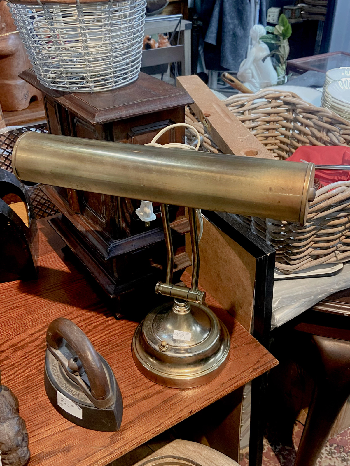 A vintage brass at surrounded by other antique items.