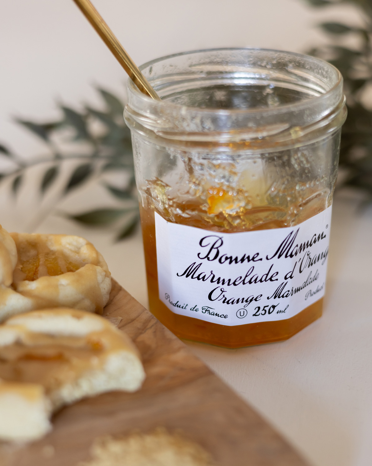 A jar of Bonne Maman marmalade with thumbprint cookies.