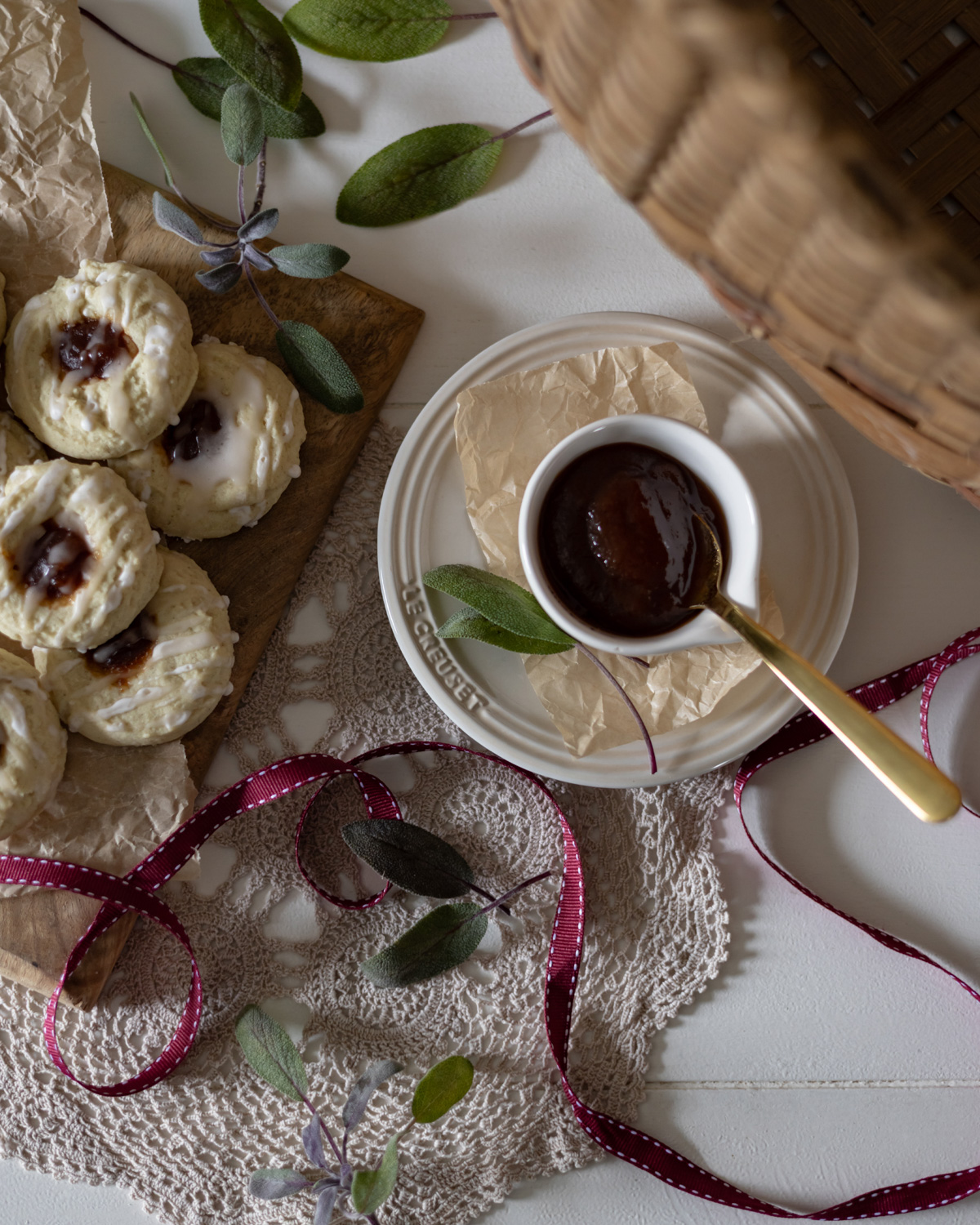 Top view of stacked cookies with fresh sage and apple butter.