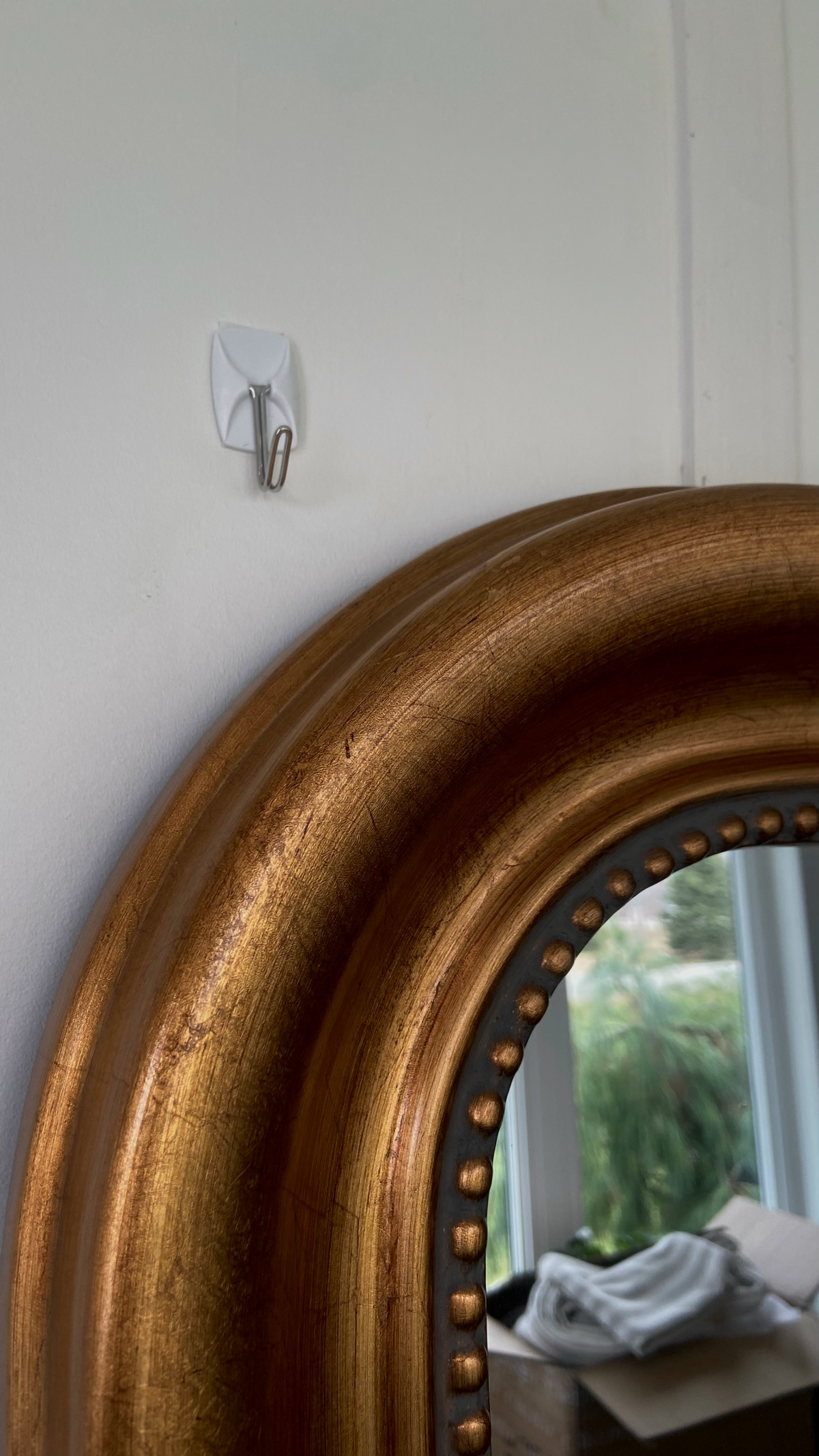 Placing small command hooks to hang garland over a mirror.