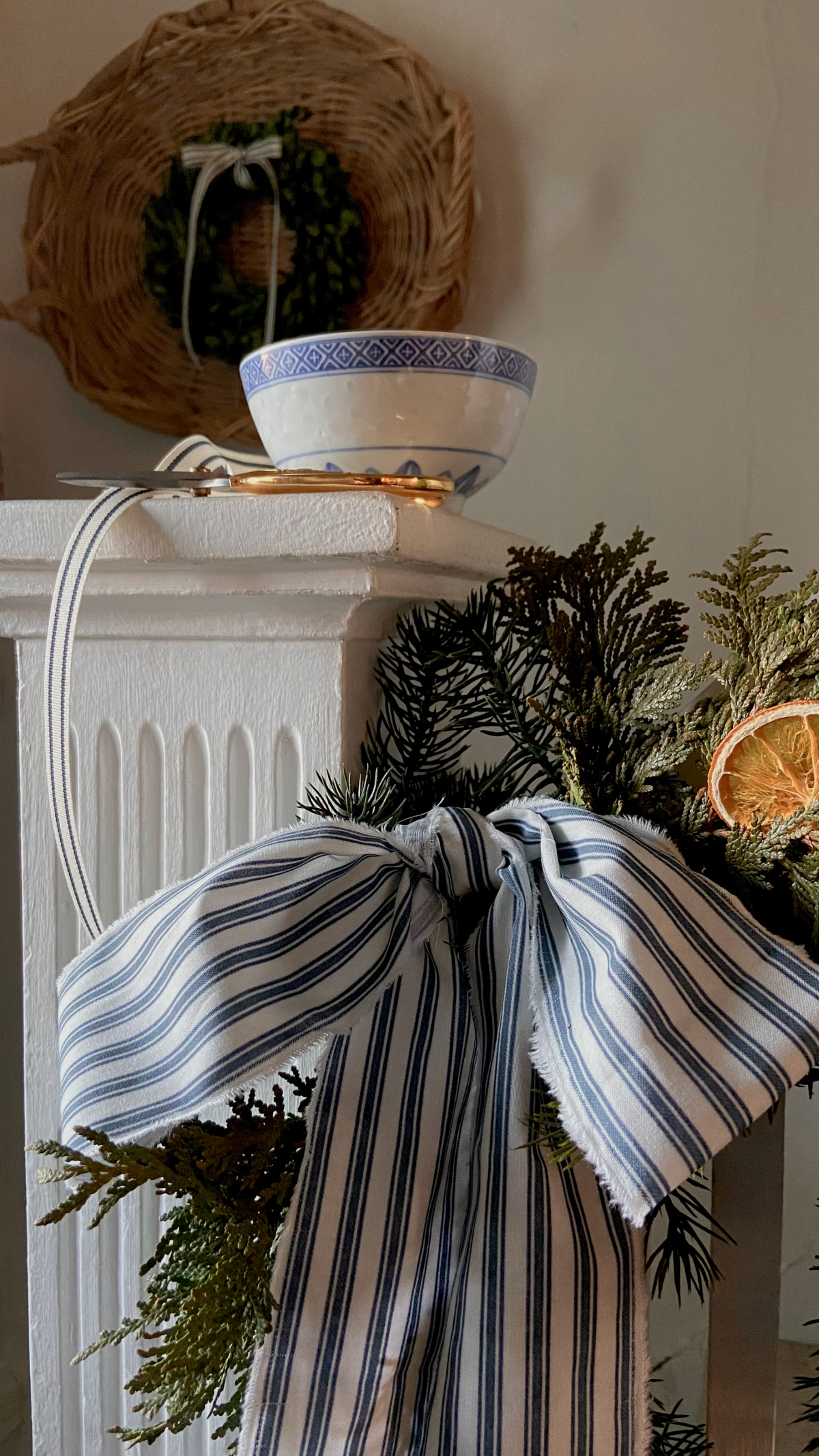 A striped bow on a stair railing.