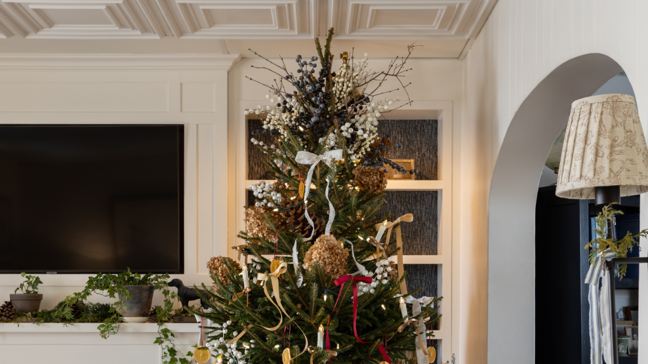 DIY berry Christmas tree topper with blue and white berries.