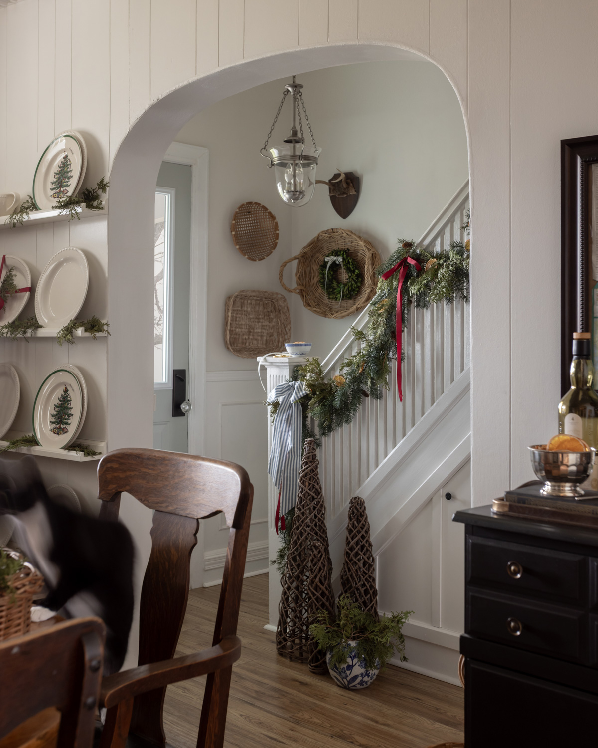 Christmas front hall with garlands on stair railings.