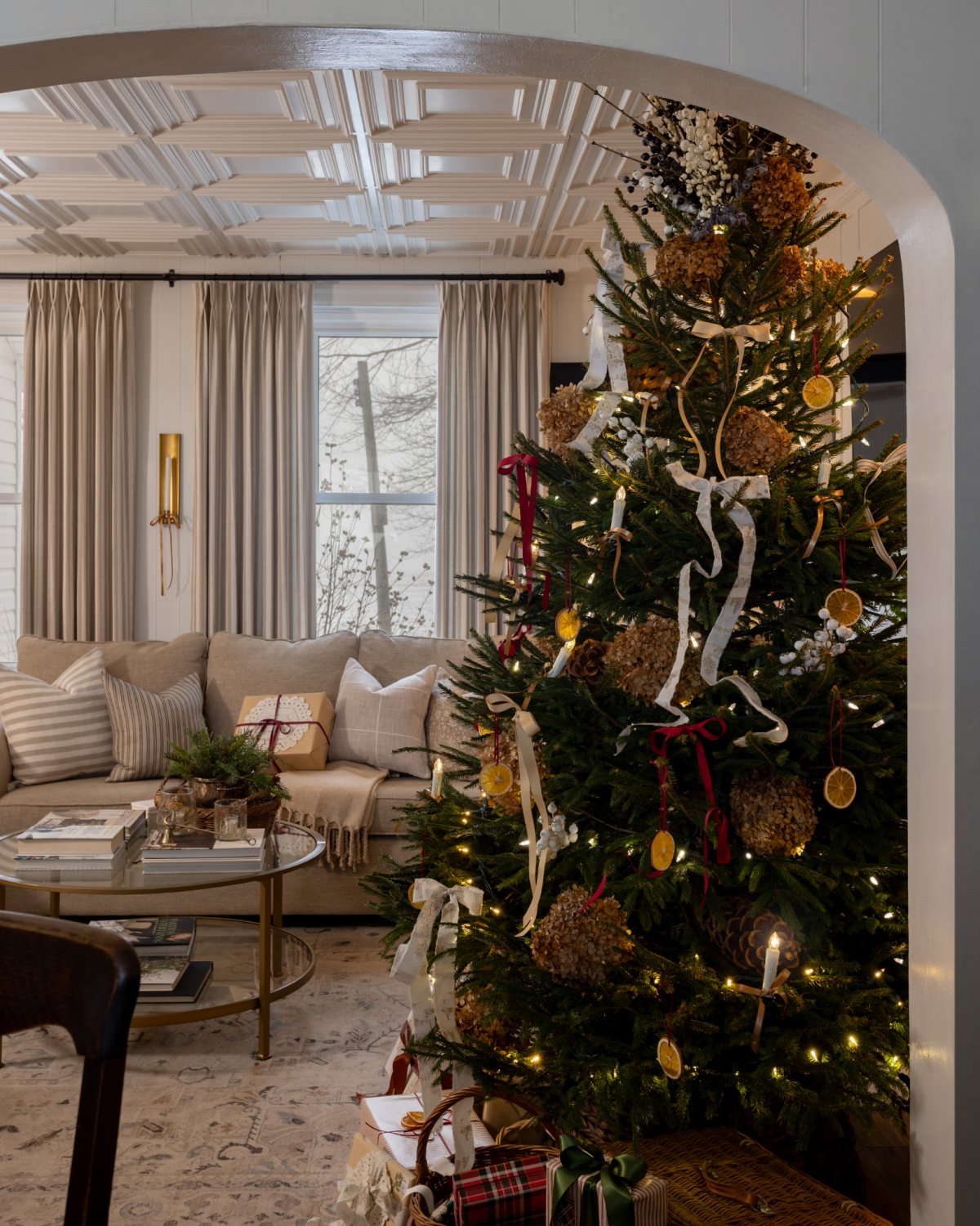 English Country Christmas living room with bows and striped curtains.