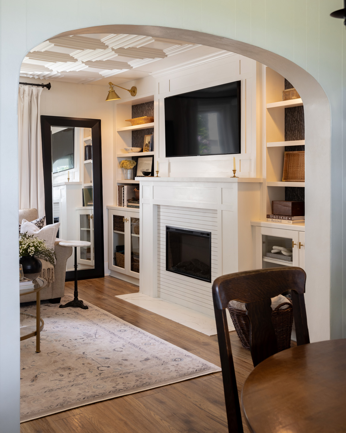 Built-in bookshelves and cabinets on either side of a living room fireplace.