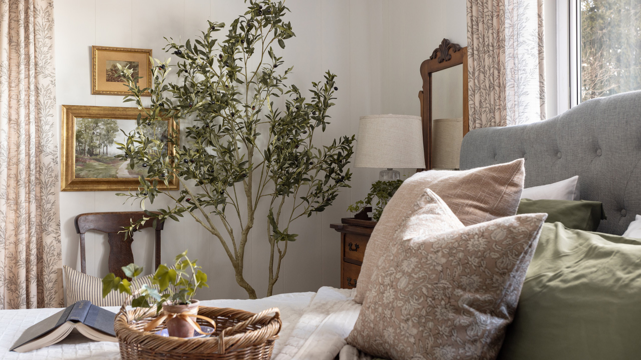 Faux olive tree in a bedroom.
