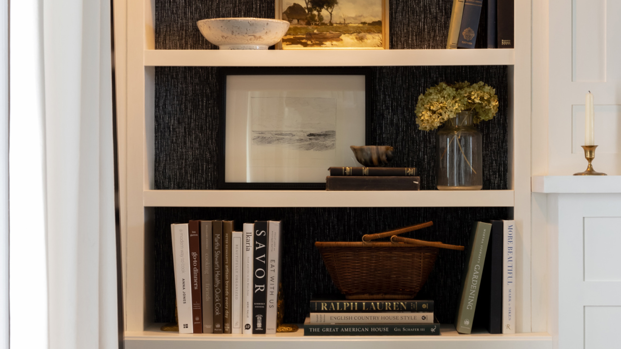 Traditional interior design books styled on a bookshelf.