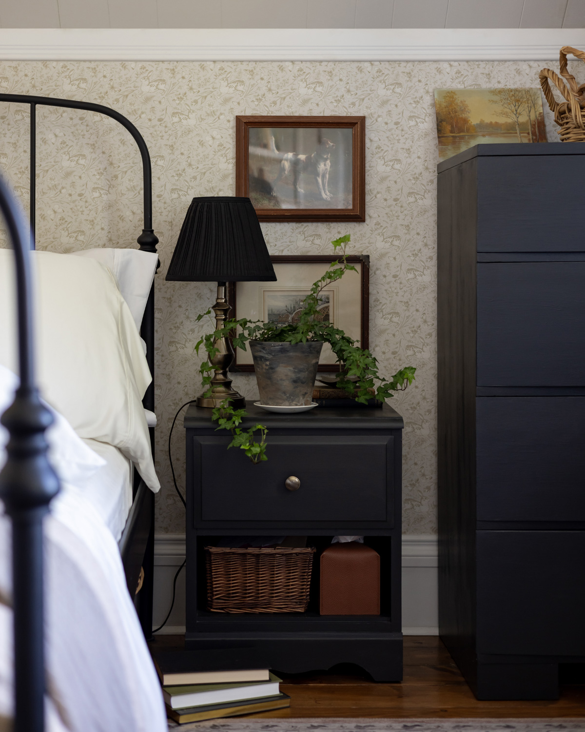 A stick style lamp on a bedside table.