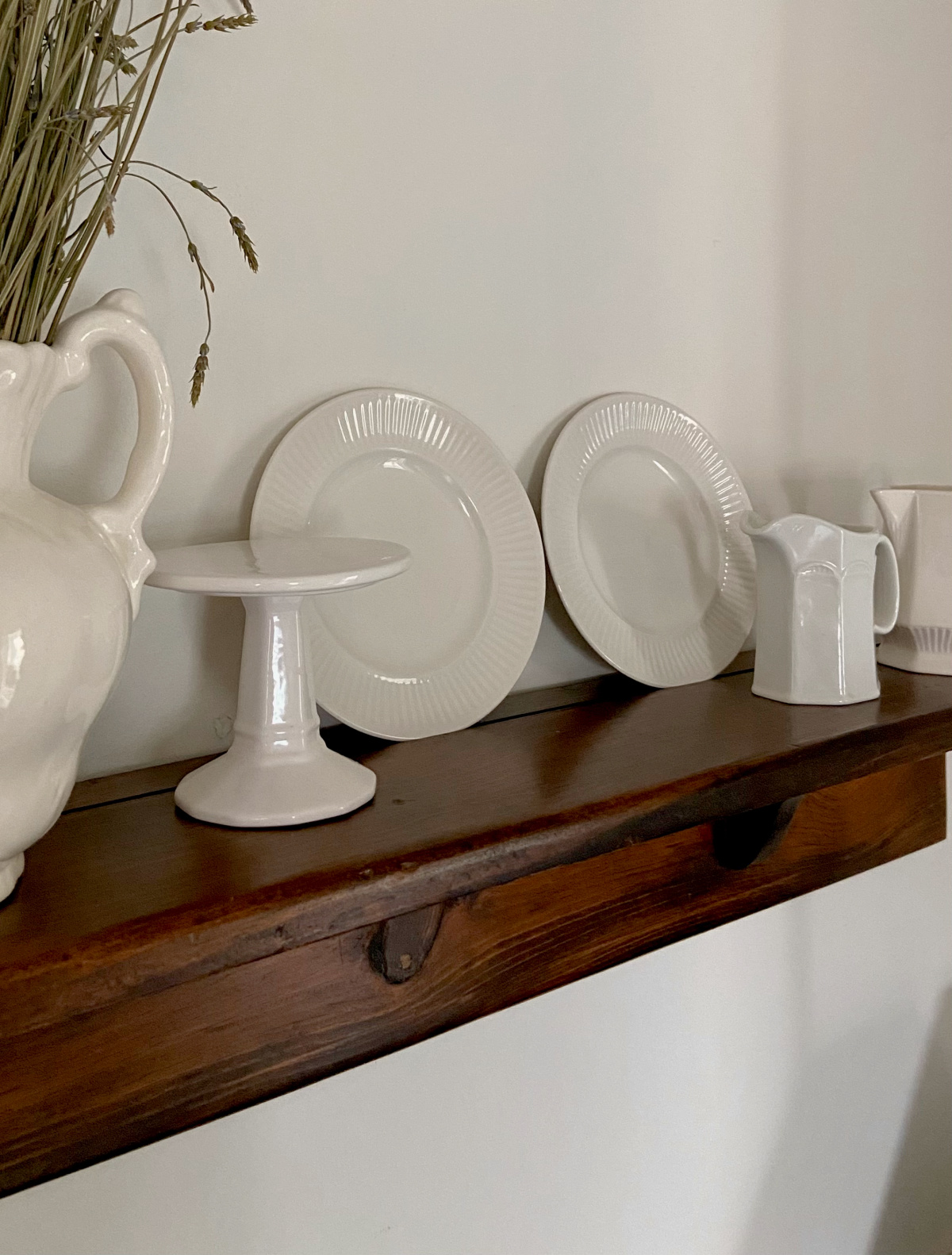 Ironstone displayed on a kitchen shelf.